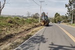 Estrada José Peres Gonzalez, no bairro Pau D’Alhinho, recebeu corte de mato e limpeza do acostamento nesta terça-feira (15)
