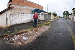 Dirceu Alves confere buraco, lixo e entulho em frente a calçada ponto de ônibus da rua Macatuba.