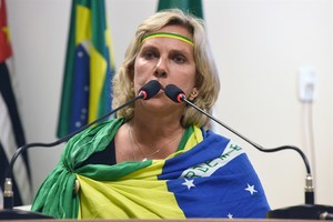 Enrolada na bandeira, Márcia Pacheco canta o Hino Nacional Brasileiro